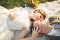 Close up portrait of couple against river and green trees. Beautiful young woman kissing handsome man outdoors Royalty Free Stock Photo