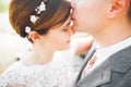 Close up portrait of couple against river and green trees. Beautiful young woman kissing handsome man outdoors Royalty Free Stock Photo