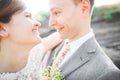 Close up portrait of couple against river and green trees. Beautiful young woman kissing handsome man outdoors Royalty Free Stock Photo