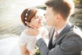 Close up portrait of couple against river and green trees. Beautiful young woman kissing handsome man outdoors Royalty Free Stock Photo