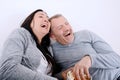 Portrait of couple laughing watching television and eating pop c Royalty Free Stock Photo