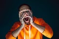 Close up portrait of crazy scared and shocked man isolated on dark background