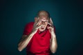 Close up portrait of crazy scared and shocked man isolated on dark background