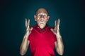 Close up portrait of crazy scared and shocked man isolated on dark background