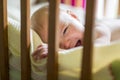 Close-up portrait of a crying cute baby in the crib at home Royalty Free Stock Photo
