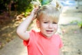 Close up portrait of crying little toddler girl with outdoors background. Child feelings and emothions concept. Seelctive focus, c Royalty Free Stock Photo