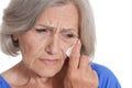 Close up portrait of crying senior woman isolated