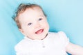 Close up portrait of curly baby girl in a white dres