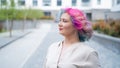 Close-up portrait of curly Caucasian woman with multi-colored hair. Model for hairstyles