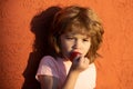 Close up portrait of cute baby kid with strawberry, outdoor. Cute happy baby boy with strawberry, outdoor.