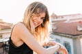 Close-up portrait of cute blonde girl with charming smile standing on observation deck in morning. Elegant young woman Royalty Free Stock Photo