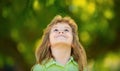 Close up portrait of cute boy looking up outdoors. Closeup headshot portrait of smiling little boy on nature background Royalty Free Stock Photo