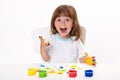 Close-up portrait of a cute cheerful happy smiling little girl draws her own hands with gouache or finger paints isolated on white Royalty Free Stock Photo