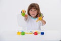 Close-up portrait of a cute cheerful happy smiling little girl draws her own hands with gouache or finger paints isolated on white Royalty Free Stock Photo