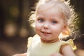 Close-up portrait of cute cheerful little girl in park Royalty Free Stock Photo