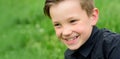 Close up portrait of cute child outdoors. Spring banner for website header. Happy child, adorable kid boy. Spring and