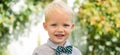 Close up portrait of cute child outdoors. Spring banner for website header. Happy child with bowtie, adorable lovely kid