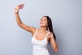 Close up portrait of cute excited latin girl making selfie with Royalty Free Stock Photo