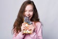 Close up portrait of cute girl eating Chocolate over grey background and smile Royalty Free Stock Photo