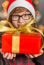 Close-up portrait of cute girl holding wrapped Christmas present Royalty Free Stock Photo