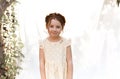 Close up portrait of cute little adorable redhead girl with curly hair with braid wearing yellow dotted dress