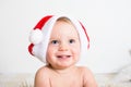 Close up portrait of a cute little baby with red Santa Claus hat isolated on white background. Small smiling kid face. Christmas Royalty Free Stock Photo