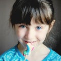 Close-up portrait of cute little girl with candy