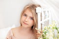 Close-up portrait of a cute little girl. Portrait of a beautiful little girl with long blonde hair on the bed in a bright bedroom Royalty Free Stock Photo