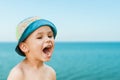Close-up portrait of a cute, smiling young child at the beach. People, travel, holidays and tourism concept. Royalty Free Stock Photo