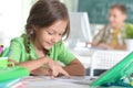 Cute teen girl doing homework in her room Royalty Free Stock Photo