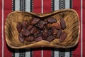 Close-up portrait of dates on a wooden platter. Royalty Free Stock Photo