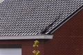 A close up portrait of a destroyed black tile roof of a house. The building got damaged by a big storm with high wind speeds on Royalty Free Stock Photo