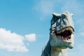 Close-up portrait of dinosaur tyrannosaurus against blue sky