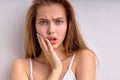 close-up portrait of dissatisfied young woman with natural straight hair looking outraged