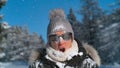 CLOSE UP: Woman is shocked after being struck in the face by a big snowball.