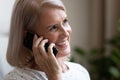 Closeup portrait 60s female holding mobile phone talking with friend Royalty Free Stock Photo