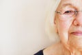 Close up portrait of an elderly woman in eyeglasses. Half face elderly woman. Eye diseases concept.