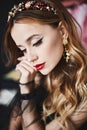 Close up portrait of elegant luxurious woman with perfect makeup and expensive trendy gold jewelry. Model girl with wavy