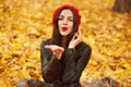 Close up portrait of elegant pretty brunette woman posing at autumn bright day in city park, wearing elegant red beret and stylish Royalty Free Stock Photo