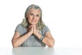 Close up portrait of emotional senior woman at table