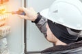 Close-up portrait of energy engineer in hard hat at work.