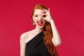 Close-up portrait of enthusiastic luxurious gorgeous redhead woman with long curly red hair, black dress and lipstick Royalty Free Stock Photo