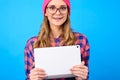 Close up portrait of excited cheerful satisfied teen girl wearing casual checkered shirt pink hat nerd eyewear hugging white with