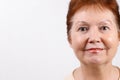 Close-up portrait of the face adult woman on a white background in a light T-shirt. place for text, isolated Royalty Free Stock Photo