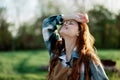 Close-up portrait of the face of a smiling, beautiful redheaded young woman in nature in a green park at sunset Royalty Free Stock Photo