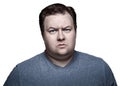 Close up portrait of fat man in studio sceptical. Isolated on white background. Royalty Free Stock Photo