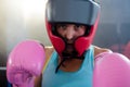 Close-up portrait of female boxer wearing protective headgear