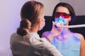 Close-up portrait of a female patient visiting dentist for teeth whitening in clinic,Teeth whitening procedure. Royalty Free Stock Photo