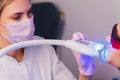 Close-up portrait of a female patient visiting dentist for teeth whitening in clinic,Teeth whitening procedure. Royalty Free Stock Photo