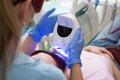 Close-up portrait of a female patient visiting dentist for teeth whitening in clinic. Woman showing her perfect straight Royalty Free Stock Photo